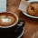 a cup of coffee and a bagel on a table