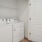 a white closet with a washer and dryer